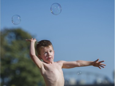 Jared Francis, age 4, chases bubbles as he waits for the fireworks display from team USA Disney at the Honda Celebration of Light.