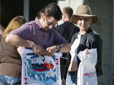 Fans gather before the concert and purchase merchandise prior to attending the first concert of the Tragically Hip's final tour at the Save On Foods Memorial Centre in Victoria on Friday night.