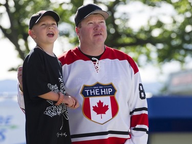 Jade Robinson waits with his son Aidan Robinson as they get ready to attend the first concert of the Tragically Hip's final tour at the Save On Foods Memorial Centre in Victoria on Friday. It is Aidan's first concert ever.