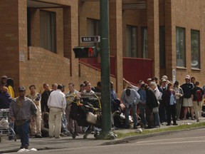 The needy line up at Powell and Main on Welfare Wednesday.