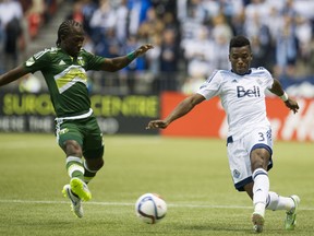 Vancouver Whitecaps' Sam Adekugbe battles against the Portland Timbers in 2015.