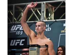 Welterweight fighter Rory MacDonald salutes the crowd during weigh-ins for UFC 189.