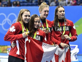 Brittany Maclean, Katerine Savard, Taylor Ruck and Penny Oleksiak and their Canadian swim teammates are the team of the year, say CP.