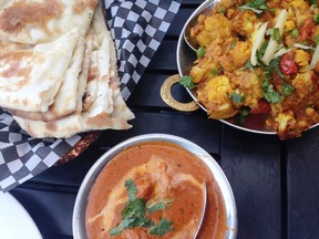 Clockwise from left: Naan, cauliflower and potato Aloo Gobi, and Butter Chicken at the Tasty Indian Bistro.