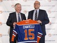 Edmonton Oilers CEO Bob Nicholson, left, and new President and General Manager Peter Chiarelli hold up an Oilers jersey with Chiarelli's name on it during a press conference in Edmonton, Alta., on Friday April 24, 2015. THE CANADIAN PRESS/Jason Franson