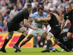 Argentina's captain Agustin Creevy, centre, is tackled by the New Zealand defence during the Rugby World Cup Pool C match between New Zealand and Argentina at Wembley Stadium, London, Sunday, Sept. 20, 2015.