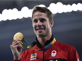 Canada's Derek Drouin (gold medal)poses during the podium ceremony for the men's High Jump during the athletics event at the Rio 2016 Olympic Games at the Olympic Stadium in Rio de Janeiro on August 17, 2016.   /