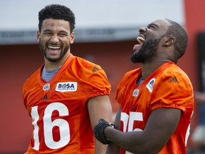 BC Lions Bryan Burnham, left shares a laugh with Shawn Gore, right during the team's practice at their facility in Surrey, B.C. Monday July 25, 2016.