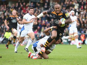 HIGH WYCOMBE, ENGLAND - OCTOBER 12:  Sailosi Tagicakibau of Wasps breaks clear to score a try despite being held by Anthony Watson during the Aviva Premiership match between Wasps and Bath at Adams Park on October 12, 2014 in High Wycombe, England.