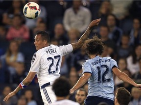 Vancouver Whitecaps forward Blas Perez (27) heads the ball against Sporting Kansas City defender Nuno Andre Coelho (12) during the first half of an MLS soccer match in Kansas City, Kan., Saturday, Aug. 20, 2016.