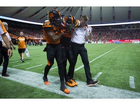B.C. Lions defensive back Steven Clarke is helped off the field during Friday's loss to Calgary. He likely has a torn ACL and will be out for the season.