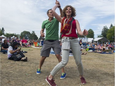 A couple dances in front of the main stage of the Burnaby Blues + Roots Festival.