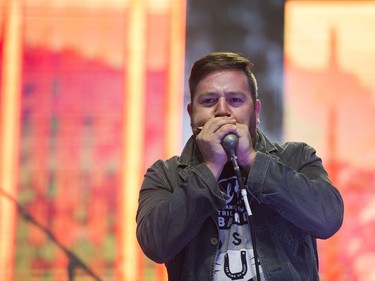 The harmonica player performing with Colin James on the main stage of the Burnaby Blues + Roots Festival.