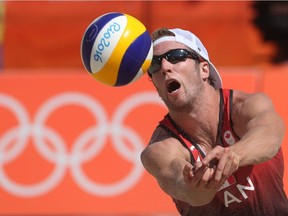 Canada's Sam Schachter sets a ball during a men's beach volleyball match against Brazil at the 2016 Summer Olympics in Rio de Janeiro, Brazil, Saturday, Aug. 6, 2016.