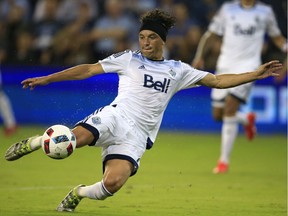 Vancouver Whitecaps midfielder Christian Bolanos puts a shot on goal during the first half of an MLS soccer match against Sporting Kansas City in Kansas City, Kan., Saturday, Aug. 20, 2016.