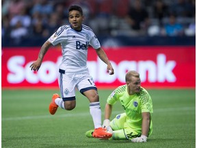 Vancouver Whitecaps' Cristian Techera, left, celebrates his goal against Sporting Kansas City goalkeeper Jon Kempin during second half CONCACAF Champions League soccer action in Vancouver in Aug., 2016.