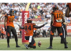 B.C. Lions wide receiver Emmanuel Arceneaux celebrates his touchdown against the Montreal Alouettes between teammates Bryan Burnham, left, and Geraldo Boldewijn during second quarter CFL football action Thursday, August 4, 2016 in Montreal.