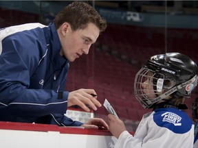 Rypien with a young player in the Canucks' First Strides program.