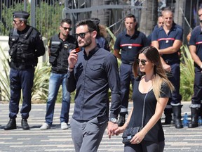 French goalkeeper Hugo Lloris (L) and his wife Marine arrive on the Promenade des Anglais in Nice to observe a minute of silence on July 18, 2016, in tribute to victims of the deadly Nice attack on Bastille day.