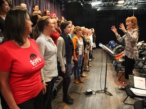 Sing City choir members learn how to 'open wide' under the instruction of Laura Lang.