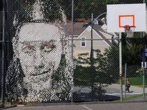 A mural of NBAer Kelly Olynyk of Kamloops adorns a fence beside a basketball court at Thompson Rivers University.
