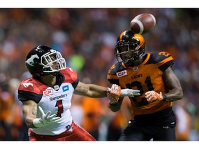 B.C.'s Ryan Phillips grabs the arm of Calgary's Lemar Durant as he tries to defend last Friday. Phillips tweeted an apology to fans after the Lions lost 37-9.