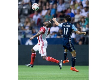 San Jose Earthquakes' Marvell Wynne, left, and Vancouver Whitecaps' Nicolas Mezquida vie for the ball during the first half of an MLS soccer game in Vancouver, B.C., on Friday August 12, 2016.