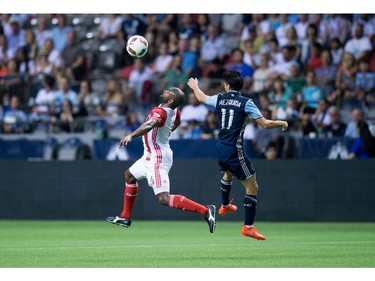 San Jose Earthquakes' Marvell Wynne, left, and Vancouver Whitecaps' Nicolas Mezquida vie for the ball during the first half of an MLS soccer game in Vancouver, B.C., on Friday August 12, 2016.