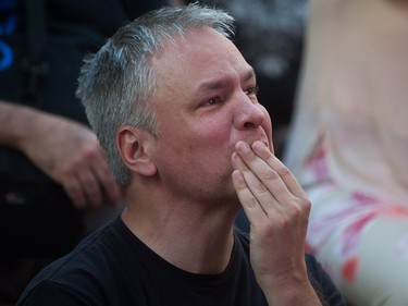 A man becomes emotional during a viewing party for the final stop in Kingston, Ont., of a 10-city national concert tour by The Tragically Hip, in Vancouver, B.C., on Saturday August 20, 2016. Lead singer Gord Downie announced earlier this year that he was diagnosed with an incurable form of brain cancer. THE CANADIAN PRESS/Darryl Dyck ORG XMIT: VCRD103