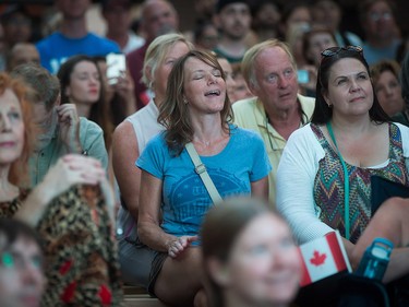 A woman sings along during a viewing party for the final stop in Kingston, Ont., of a 10-city national concert tour by The Tragically Hip, in Vancouver, B.C., on Saturday August 20, 2016. Lead singer Gord Downie announced earlier this year that he was diagnosed with an incurable form of brain cancer. THE CANADIAN PRESS/Darryl Dyck ORG XMIT: VCRD101