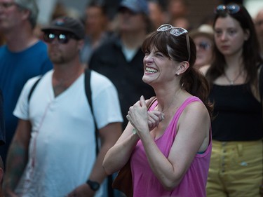 A woman reacts during a viewing party for the final stop in Kingston, Ont., of a 10-city national concert tour by The Tragically Hip, in Vancouver, B.C., on Saturday August 20, 2016. Lead singer Gord Downie announced earlier this year that he was diagnosed with an incurable form of brain cancer. THE CANADIAN PRESS/Darryl Dyck ORG XMIT: VCRD127