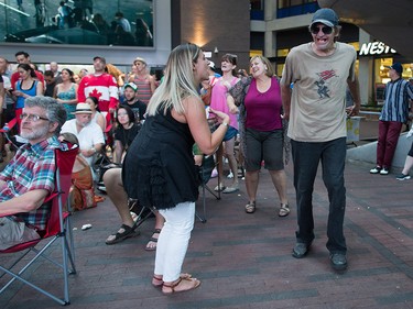 A woman and man dance during a viewing party for the final stop in Kingston, Ont., of a 10-city national concert tour by The Tragically Hip, in Vancouver, B.C., on Saturday August 20, 2016. Lead singer Gord Downie announced earlier this year that he was diagnosed with an incurable form of brain cancer. THE CANADIAN PRESS/Darryl Dyck ORG XMIT: VCRD115