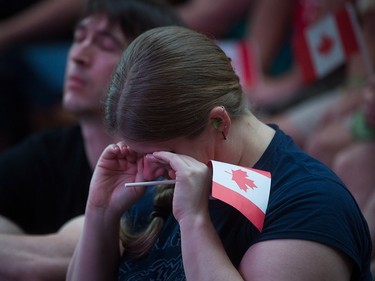 A woman wipes away tears during a viewing party for the final stop in Kingston, Ont., of a 10-city national concert tour by The Tragically Hip, in Vancouver, B.C., on Saturday August 20, 2016. Lead singer Gord Downie announced earlier this year that he was diagnosed with an incurable form of brain cancer. THE CANADIAN PRESS/Darryl Dyck ORG XMIT: VCRD123