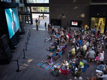 Lead singer Gord Downie is seen performing on a screen as people gather to watch during a viewing party for the final stop in Kingston, Ont., of a 10-city national concert tour by The Tragically Hip, in Vancouver, B.C., on Saturday August 20, 2016. Downie announced earlier this year that he was diagnosed with an incurable form of brain cancer. THE CANADIAN PRESS/Darryl Dyck ORG XMIT: VCRD109
