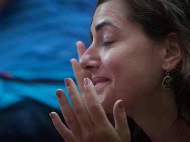A woman wipes away tears during a viewing party for the final stop in Kingston, Ont., of a 10-city national concert tour by The Tragically Hip, in Vancouver, B.C., on Saturday August 20, 2016. Lead singer Gord Downie announced earlier this year that he was diagnosed with an incurable form of brain cancer. THE CANADIAN PRESS/Darryl Dyck ORG XMIT: VCRD120