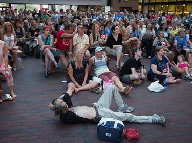 People gather during a viewing party for the final stop in Kingston, Ont., of a 10-city national concert tour by The Tragically Hip, in Vancouver, B.C., on Saturday August 20, 2016. Lead singer Gord Downie announced earlier this year that he was diagnosed with an incurable form of brain cancer. THE CANADIAN PRESS/Darryl Dyck ORG XMIT: VCRD113