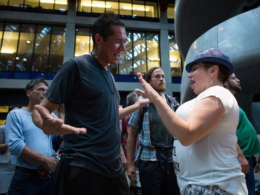 Friends, Steven Seegerts, left, and Elizabeth Robson dance during a viewing party for the final stop in Kingston, Ont., of a 10-city national concert tour by The Tragically Hip, in Vancouver, B.C., on Saturday August 20, 2016. Lead singer Gord Downie announced earlier this year that he was diagnosed with an incurable form of brain cancer. THE CANADIAN PRESS/Darryl Dyck ORG XMIT: VCRD119