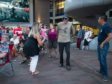 A woman and man dance during a viewing party for the final stop in Kingston, Ont., of a 10-city national concert tour by The Tragically Hip, in Vancouver, B.C., on Saturday August 20, 2016. Lead singer Gord Downie announced earlier this year that he was diagnosed with an incurable form of brain cancer. THE CANADIAN PRESS/Darryl Dyck ORG XMIT: VCRD128
