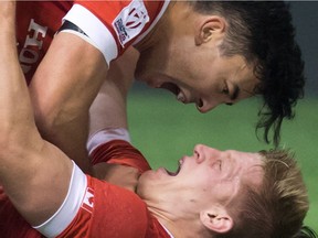 Canada's Nathan Hirayama, top, and John Moonlight celebrate after Moonlight scored the winning try in the final moments against France during World Rugby Sevens action in Vancouver on March 13. Moonlight's favourite place to play is Vancouver.