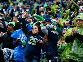 SEATTLE, WA - JANUARY 18: Seattle Seahawks fans celebrate during the second half of the 2015 NFC Championship game against the Green Bay Packers at CenturyLink Field on January 18, 2015 in Seattle, Washington.