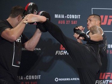 Anthony Pettis (right) works out at the Hyatt Regency hotel in Vancouver on Thursday.