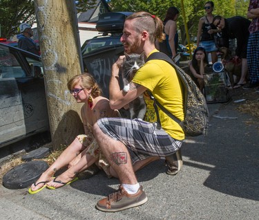 Morgan Schramek and girlfriend Erin Newman-Renwick are reunited with their three cats that were rescued by Vancouver firefighters from a burning house in the 500-block of Prior Street on Friday.