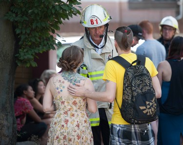 Morgan Schramek and girlfriend Erin Newman-Renwick tell firefighters about their three missing cats.