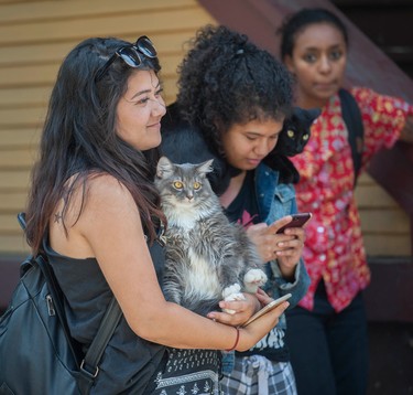 A resident from the house holds her pet cat.