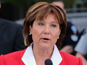 An image from a government photographer shows Premier Christy Clark announcing $23 million extra to fights gangs in a Surrey in April.