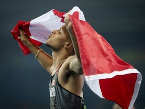 Andre De Grasse, of Canada, celebrates his bronze medal in the men's 100m final.