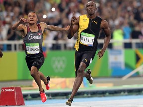 Jamaica's Usain Bolt celebrates as he crosses the line to win gold in the men's 100-meter final with Canada's Andre de Grasse during the athletics competitions of the 2016 Summer Olympics at the Olympic stadium in Rio de Janeiro, Brazil, Sunday, Aug. 14, 2016.