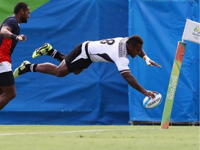 RIO DE JANEIRO, BRAZIL - AUGUST 11:  Josua Tuisova of Fiji dives to score a try during the Men's Rugby Sevens semi final match between Fiji and Japan on Day 6 of the Rio 2016 Olympics at Deodoro Stadium on August 11, 2016 in Rio de Janeiro, Brazil.
