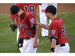 Hastings pitcher Sean Coventry, left, is comforted by teammate Liam McLean after giving up a three-run homer against East Seoul at the Little League World Series in Williamsport, Pa., Monday.