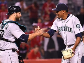 Chris Iannetta and Edwin Diaz celebrate the M's win on Tuesday vs. the Angels.